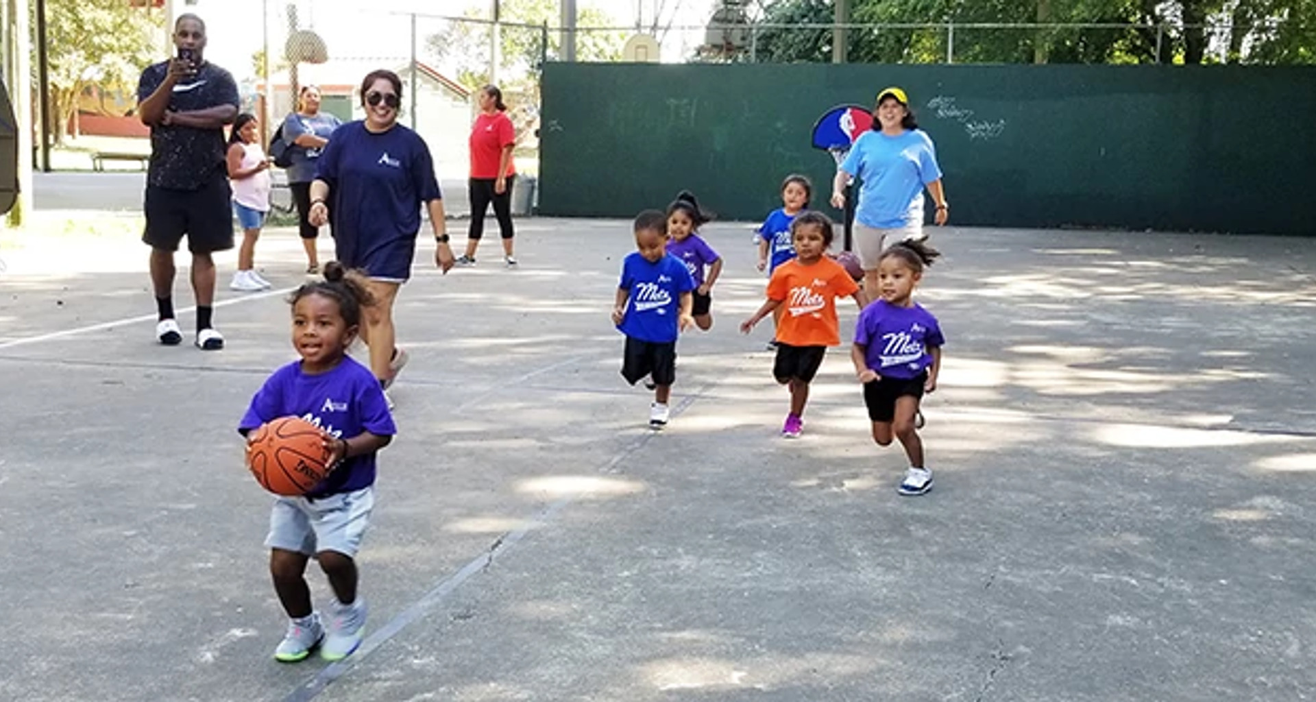 toddlers playing basketball